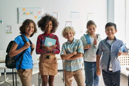 Portrait,Of,Cheerful,Smiling,Diverse,Schoolchildren,Standing,Posing,In,Classroom